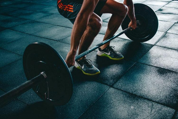 athlete doing deadlifts in gym